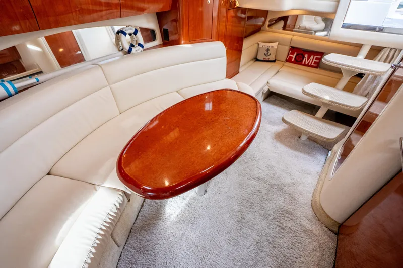 Slide: The Image of Luxurious interior of 2003 Sea Ray 360 Sundancer yacht with plush seating and elegant table. - 21