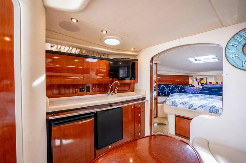 Slide: The Image of Luxurious interior of 2003 Sea Ray 360 Sundancer yacht with kitchenette and cozy sleeping area. - 22