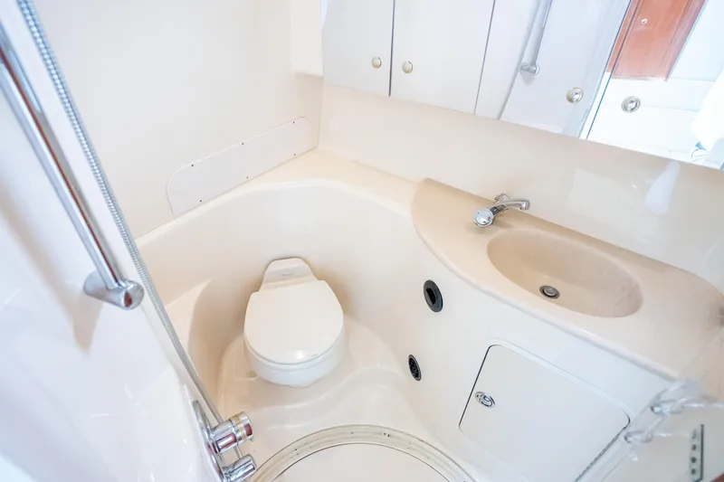 Slide: The Image of 2003 Sea Ray 360 Sundancer bathroom with toilet, sink, and shower fixtures. - 28