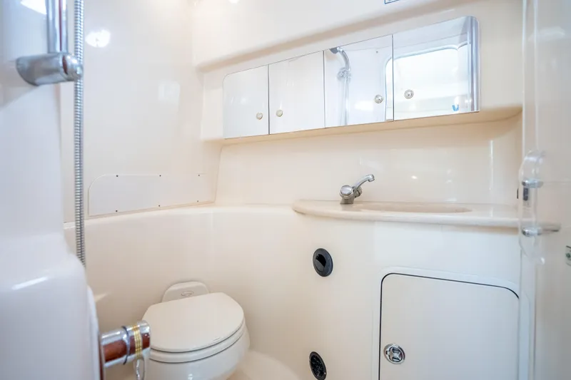 Slide: The Image of 2003 Sea Ray 360 Sundancer bathroom with sink, toilet, and storage cabinets. - 29