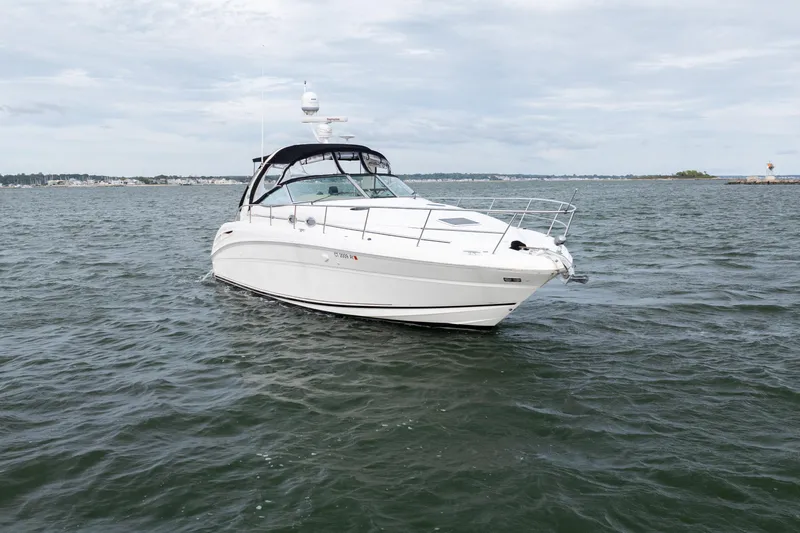 Slide: The Image of 2003 Sea Ray 360 Sundancer yacht cruising on open water under cloudy skies. - 3