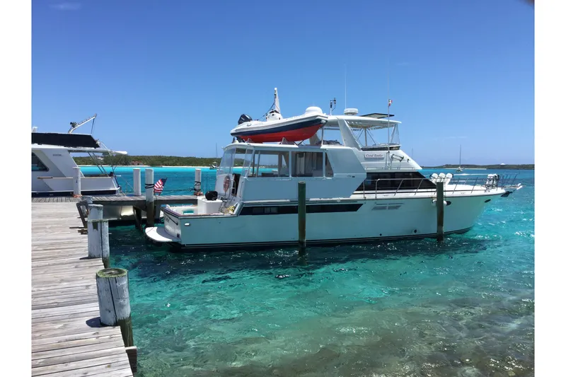 The Image of 1991 Californian 55 Cockpit Motor Yacht docked in clear turquoise water. - 0