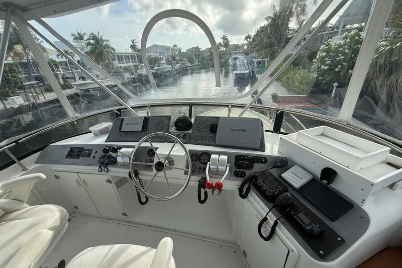 Slide: The Image of Cockpit of 1991 Californian 55 Cockpit Motor Yacht with navigation equipment and scenic canal view. - 10