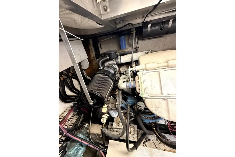 Slide: The Image of Engine room of 1991 Californian 55 Cockpit Motor Yacht, showcasing mechanical components and wiring. - 13