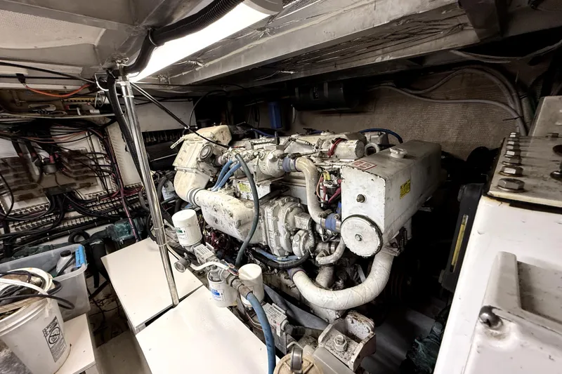 Slide: The Image of Engine room of 1991 Californian 55 Cockpit Motor Yacht, showcasing complex machinery and wiring. - 17