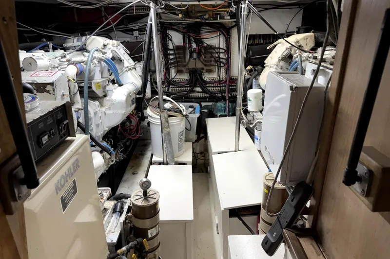 Slide: The Image of Engine room of a 1991 Californian 55 Cockpit Motor Yacht, showcasing machinery and wiring. - 19