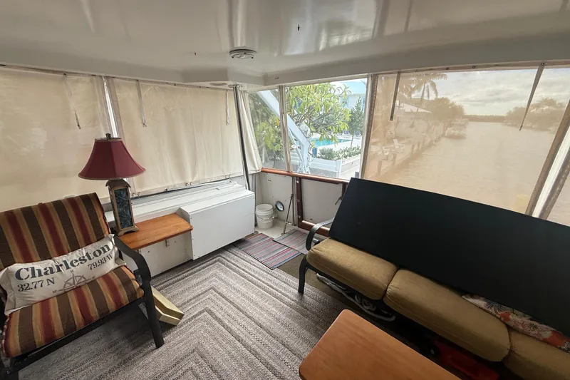 Slide: The Image of Interior of 1991 Californian 55 Cockpit Motor Yacht with cozy seating and nautical decor. - 22