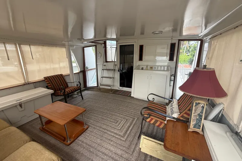 Slide: The Image of Interior of 1991 Californian 55 Cockpit Motor Yacht with cozy seating and nautical decor. - 23
