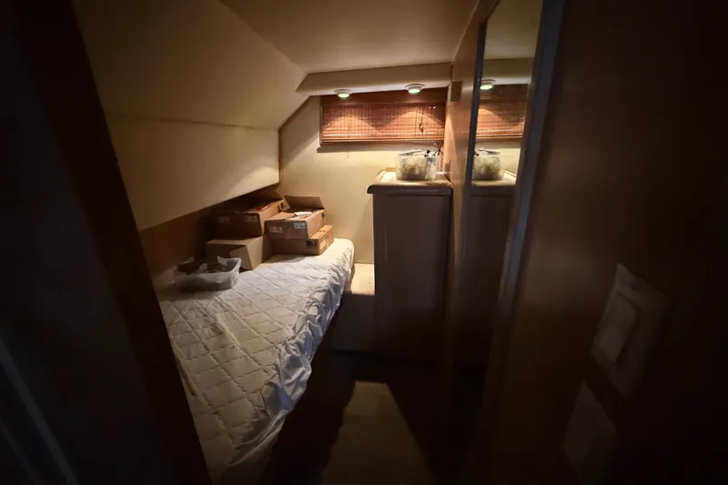 Slide: The Image of Cozy cabin interior of 1991 Californian 55 Cockpit Motor Yacht with bed and storage. - 31
