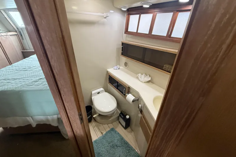 Slide: The Image of Bathroom interior of 1991 Californian 55 Cockpit Motor Yacht, featuring toilet and sink. - 33