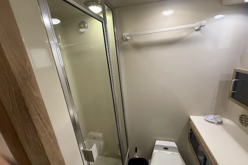 Slide: The Image of Bathroom interior of 1991 Californian 55 Cockpit Motor Yacht, featuring shower and toilet. - 35