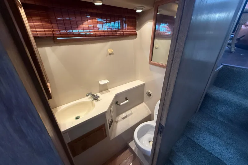 Slide: The Image of Bathroom interior of 1991 Californian 55 Cockpit Motor Yacht with sink and toilet. - 38
