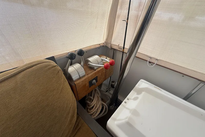 Slide: The Image of 1991 Californian 55 Cockpit Motor Yacht controls with throttle levers and ropes. - 42