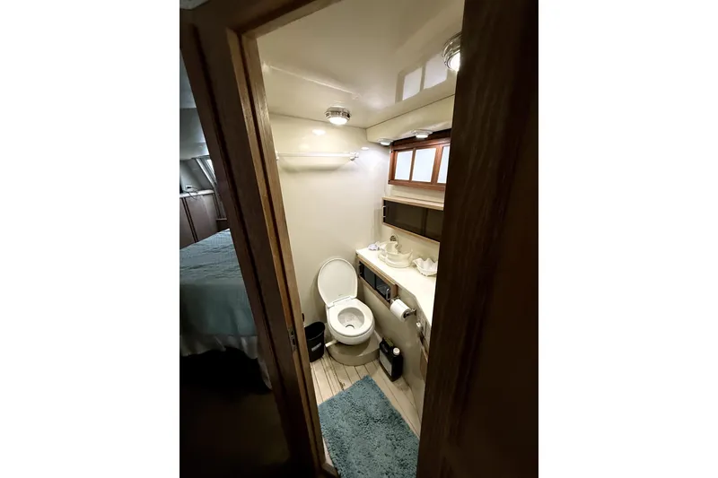 Slide: The Image of Bathroom interior of 1991 Californian 55 Cockpit Motor Yacht, featuring toilet and sink. - 6