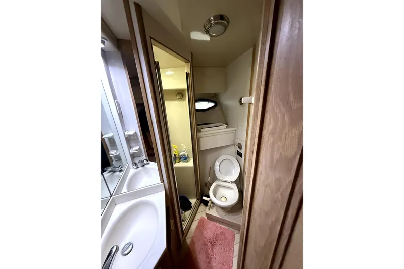 Slide: The Image of Bathroom interior of 1991 Californian 55 Cockpit Motor Yacht, featuring sink and toilet. - 7