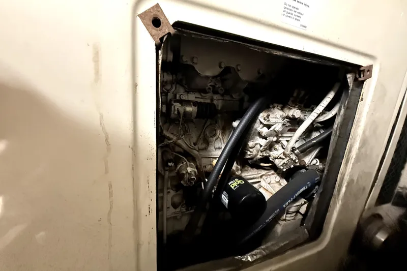 Slide: The Image of Engine compartment of a 1991 Californian 55 Cockpit Motor Yacht, showing mechanical components. - 8