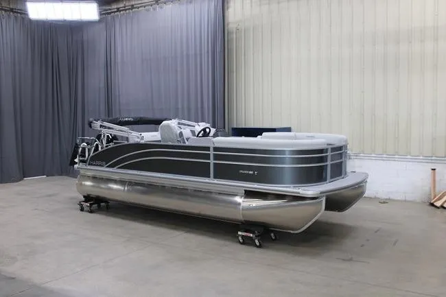 The Image of 2026 Harris Cruiser 210 pontoon boat in a showroom setting. - 1