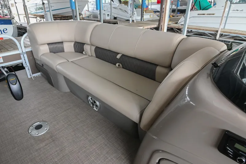 Slide: The Image of 2023 SUNTRACKER DLX 22 Sportfish boat interior with beige seating and modern design. - 23