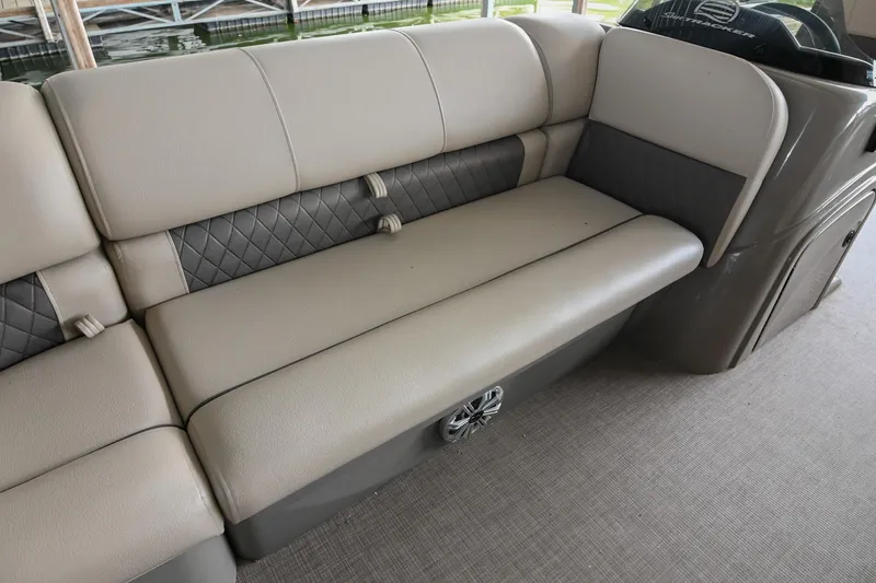 Slide: The Image of 2023 SUNTRACKER DLX 22 Sportfish boat interior seating with quilted upholstery. - 24