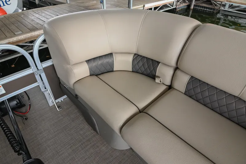 Slide: The Image of 2023 SUNTRACKER DLX 22 Sportfish boat seating with beige and black upholstery. - 26