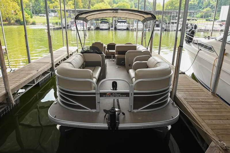 Slide: The Image of 2023 SUNTRACKER DLX 22 Sportfish pontoon boat docked in a marina. - 3
