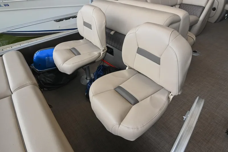Slide: The Image of 2023 SUNTRACKER DLX 22 Sportfish boat interior with beige seating and modern design. - 9
