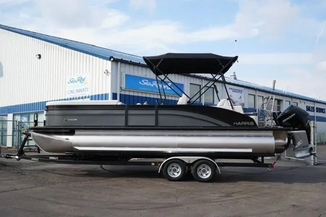 The Image of 2026 Harris Cruiser 250 pontoon boat on trailer outside dealership. - 3