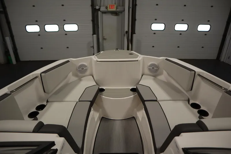 Slide: The Image of 2026 Yamaha Boats SX220 interior with spacious seating and modern design in a garage setting. - 10
