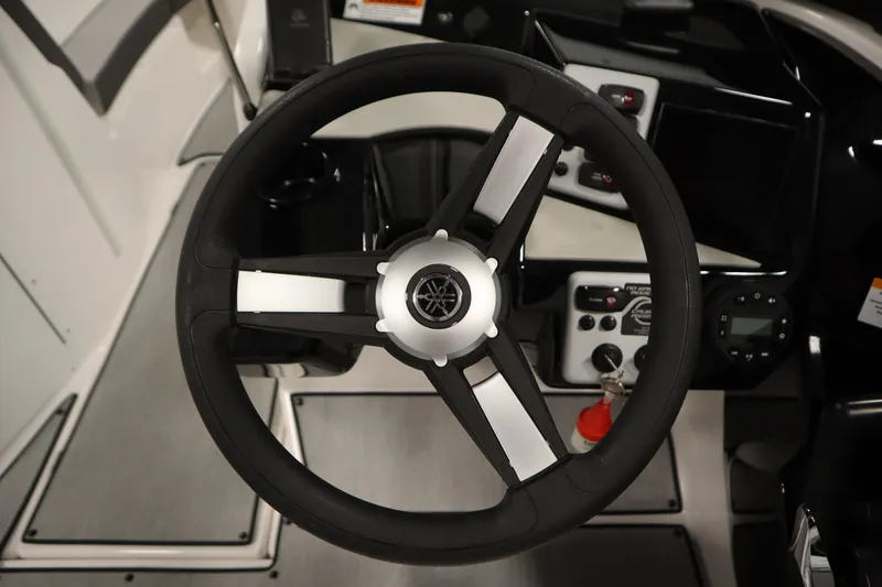 Slide: The Image of Steering wheel and dashboard of 2026 Yamaha Boats SX220, showcasing modern controls. - 20
