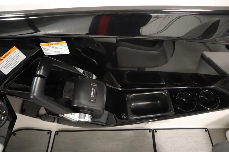 Slide: The Image of 2026 Yamaha Boats SX220 control panel with sleek black design and cup holders. - 24