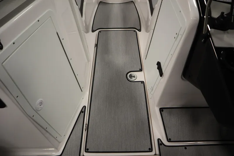 Slide: The Image of 2026 Yamaha Boats SX220 interior with sleek flooring and storage compartments. - 27