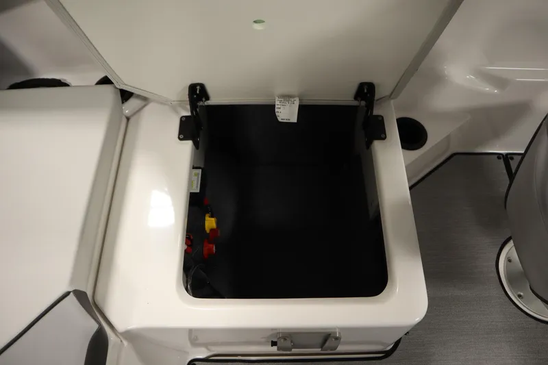 Slide: The Image of Open storage compartment in 2026 Yamaha Boats SX220, featuring sleek design and practical space. - 32