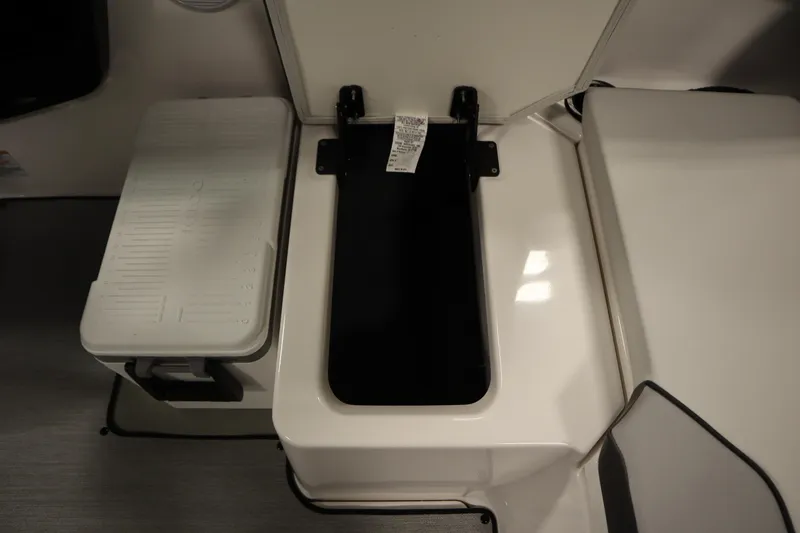 Slide: The Image of 2026 Yamaha Boats SX220 interior storage compartment and cooler. - 35