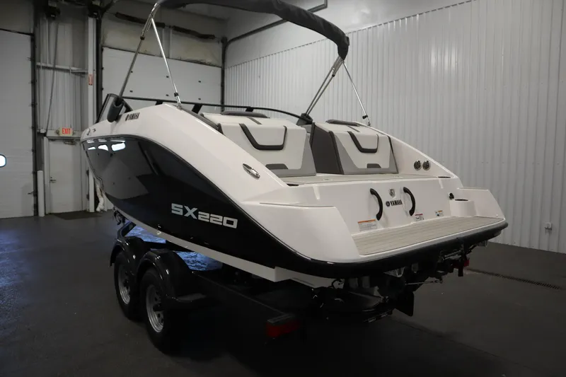 Slide: The Image of 2026 Yamaha Boats SX220 in a showroom, rear view with sleek design. - 6