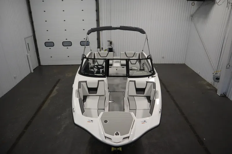 Slide: The Image of 2026 Yamaha Boats SX220 in a showroom, featuring sleek design and spacious seating. - 8