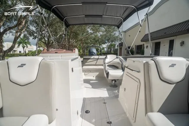 Slide: The Image of 2023 Starcraft SVX 231 OB DH boat interior with seating and canopy, showcasing modern design. - 10