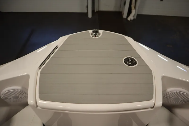 Slide: The Image of 2026 Yamaha Boats SX220 interior seating with cup holders and speaker. - 11