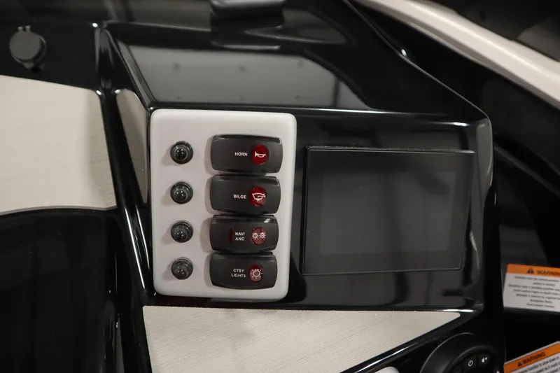 Slide: The Image of Interior of 2026 Yamaha Boats SX220, featuring control panel and cup holders. - 23