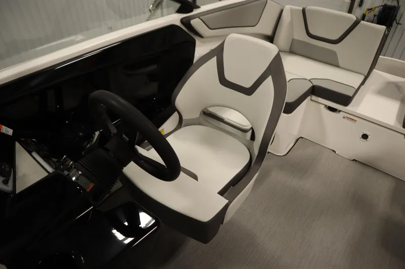 Slide: The Image of Interior of 2026 Yamaha Boats SX220 featuring a phone holder and dashboard details. - 26