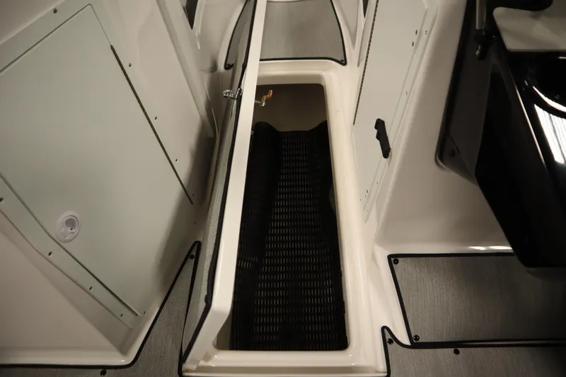 Slide: The Image of 2026 Yamaha Boats SX220 interior storage compartment with sleek design and practical features. - 29