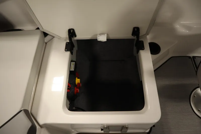 Slide: The Image of Open storage compartment on 2026 Yamaha Boats SX220, showcasing interior space and design. - 35
