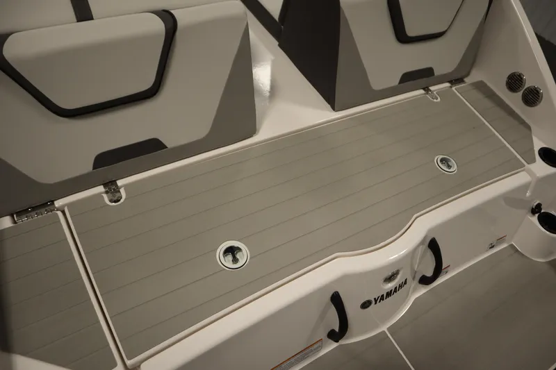 Slide: The Image of 2026 Yamaha Boats SX220 storage compartment and cooler, showcasing interior features. - 39