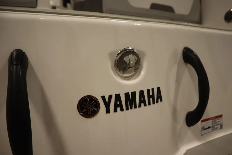 Slide: The Image of 2026 Yamaha Boats SX220 storage compartment with open lid, showcasing interior design. - 41