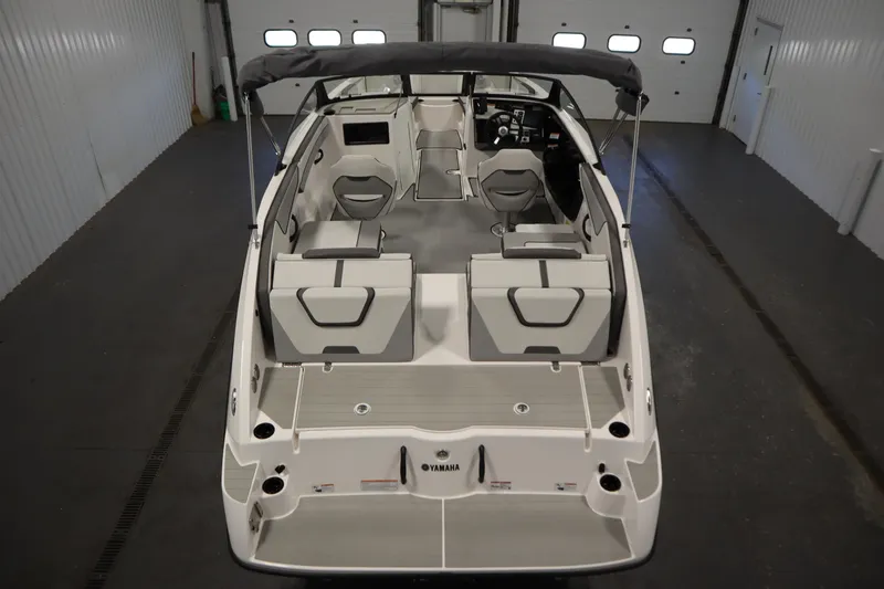Slide: The Image of 2026 Yamaha Boats SX220 in a garage, showcasing sleek design and spacious seating. - 9