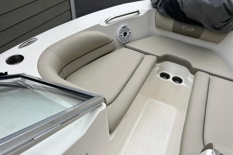 Slide: The Image of 2022 Key West 203 DFS boat interior with beige seating and cup holders. - 10