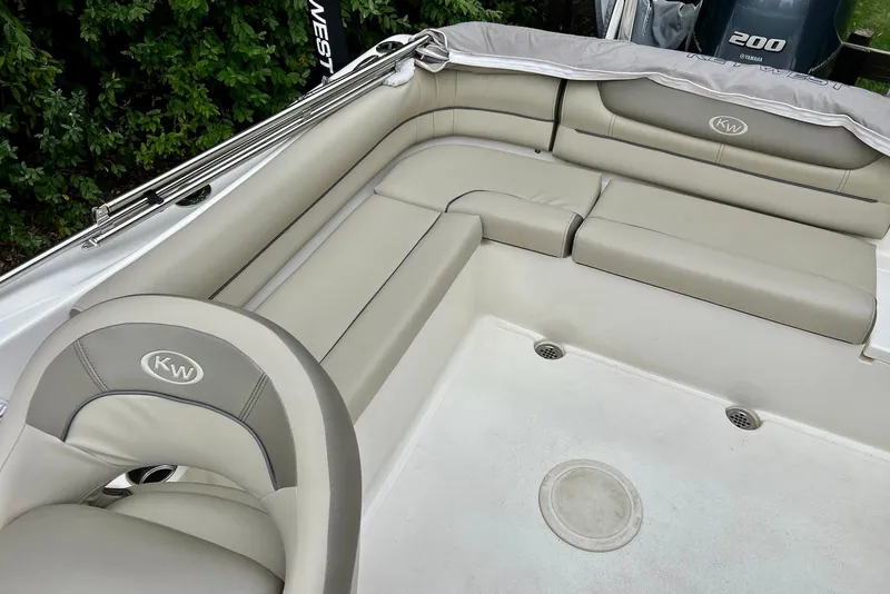 Slide: The Image of 2022 Key West 203 DFS boat interior with cushioned seating and sleek design. - 4