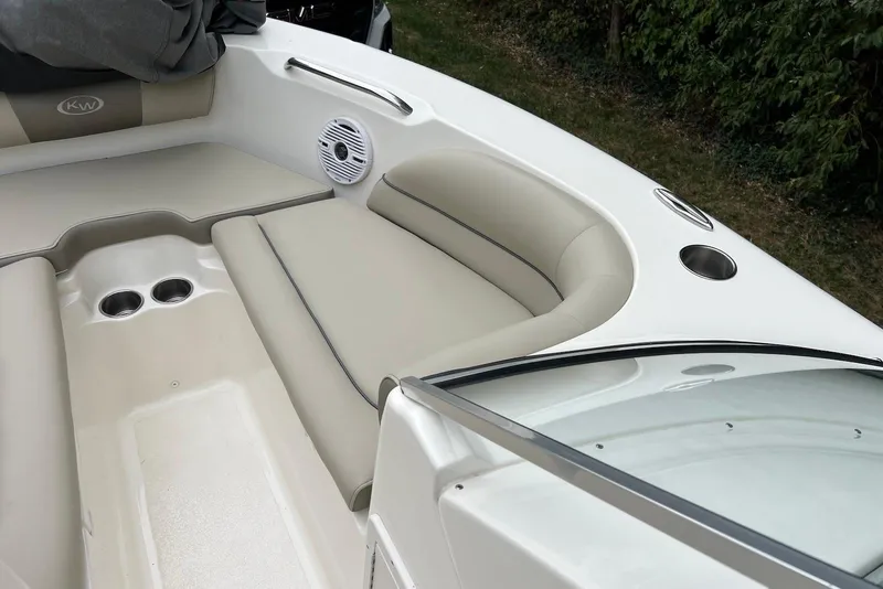 Slide: The Image of 2022 Key West 203 DFS boat interior with beige seating and cup holders. - 8