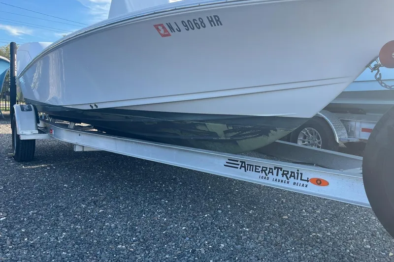 Slide: The Image of 2022 Sportsman Masters 207 Bay Boat on AmeraTrail trailer, parked on gravel. - 4