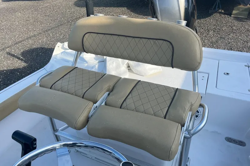 Slide: The Image of 2022 Sportsman Masters 207 Bay Boat with tan cushioned seating and stainless steel frame. - 7