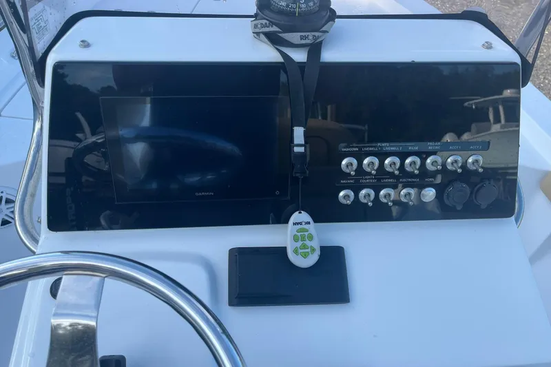 Slide: The Image of Dashboard of a 2022 Sportsman Masters 207 Bay Boat with controls and Garmin display. - 8